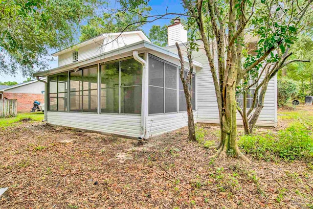 view of side of property featuring a sunroom