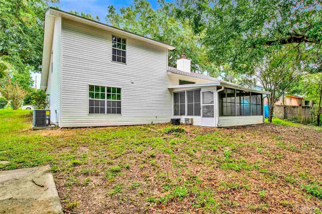 back of house with a sunroom and central AC