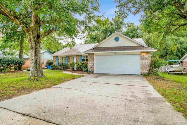 view of front of home featuring a front yard and a garage