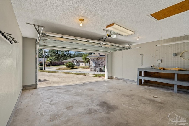 garage with a garage door opener and a workshop area