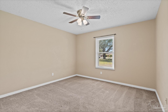 carpeted empty room featuring ceiling fan and a textured ceiling