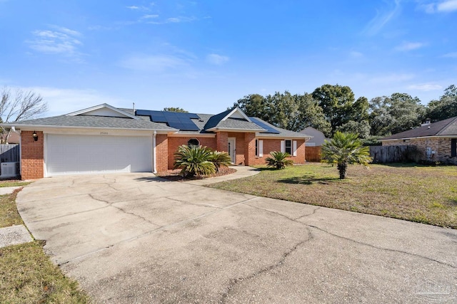 single story home with a front lawn, a garage, and solar panels