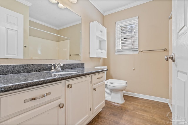 bathroom with toilet, a shower, hardwood / wood-style flooring, ornamental molding, and vanity