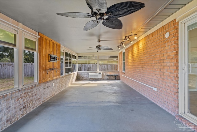 view of patio / terrace with an AC wall unit and ceiling fan