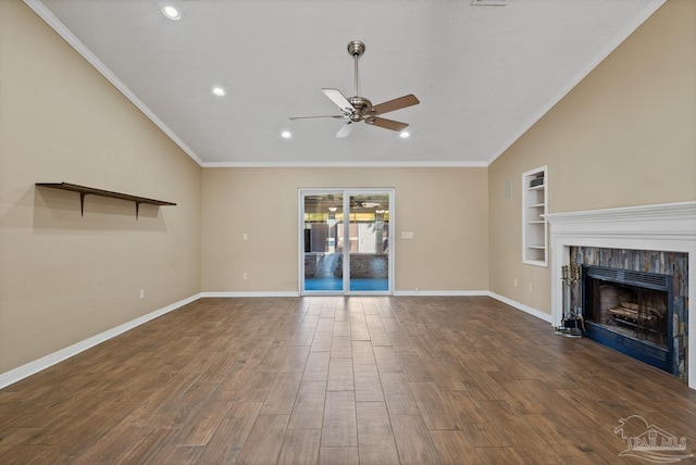 unfurnished living room featuring ceiling fan, dark wood-type flooring, lofted ceiling, ornamental molding, and built in shelves