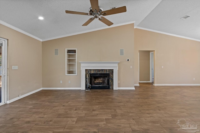 unfurnished living room with ceiling fan, built in features, ornamental molding, and a textured ceiling