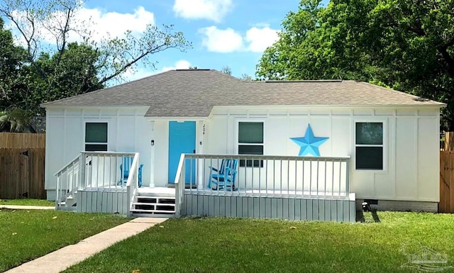 rear view of property with a yard and a deck