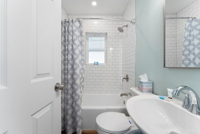 full bathroom with shower / bathtub combination with curtain, sink, and toilet