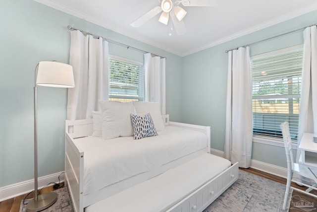 bedroom featuring crown molding, ceiling fan, and wood-type flooring