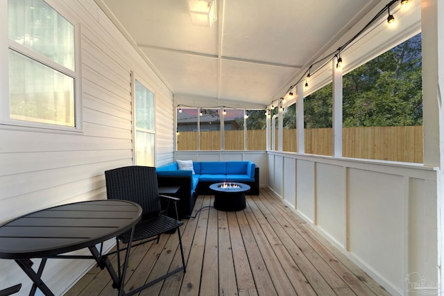 exterior space featuring an outdoor living space with a fire pit