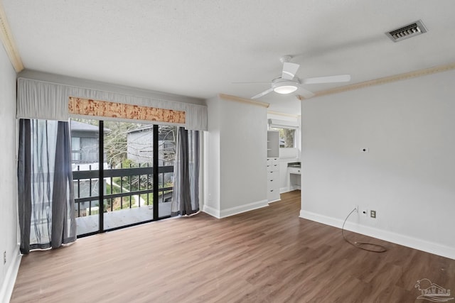 unfurnished room featuring ornamental molding, ceiling fan, and hardwood / wood-style floors