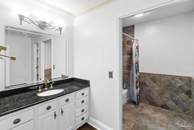 bathroom featuring vanity, shower / bath combo, tile patterned flooring, and crown molding