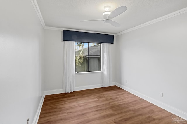 empty room featuring a textured ceiling, ceiling fan, hardwood / wood-style floors, and crown molding