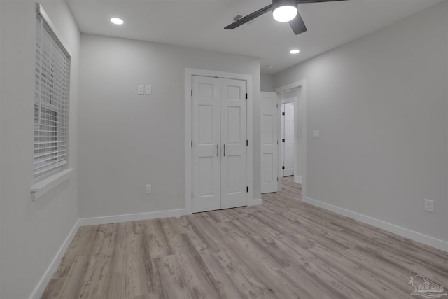 unfurnished bedroom with a closet, light hardwood / wood-style floors, and ceiling fan