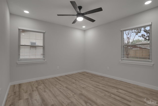 empty room featuring ceiling fan and light hardwood / wood-style floors