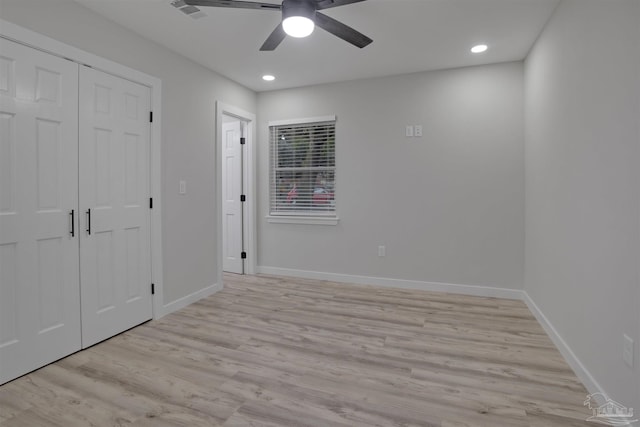 unfurnished bedroom with a closet, light hardwood / wood-style floors, and ceiling fan