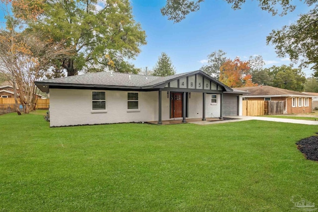 rear view of house featuring a lawn