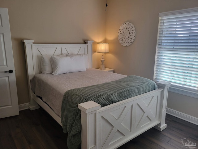 bedroom with dark wood-type flooring