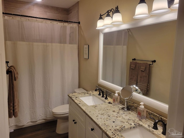 bathroom with toilet, a shower with curtain, vanity, and wood-type flooring