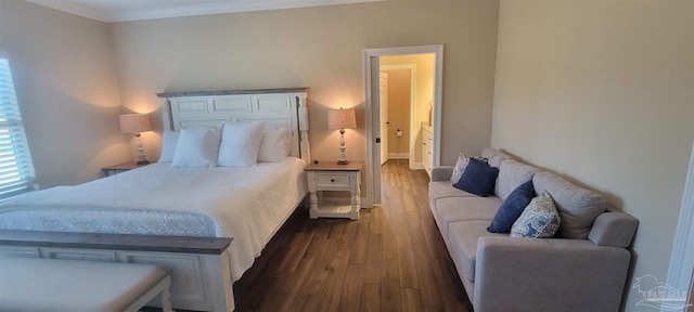 bedroom featuring ornamental molding and dark hardwood / wood-style flooring