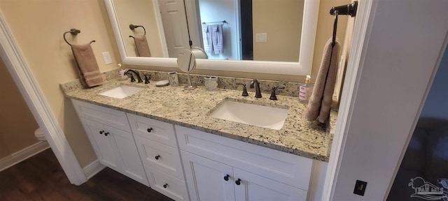 bathroom featuring vanity, hardwood / wood-style floors, and toilet