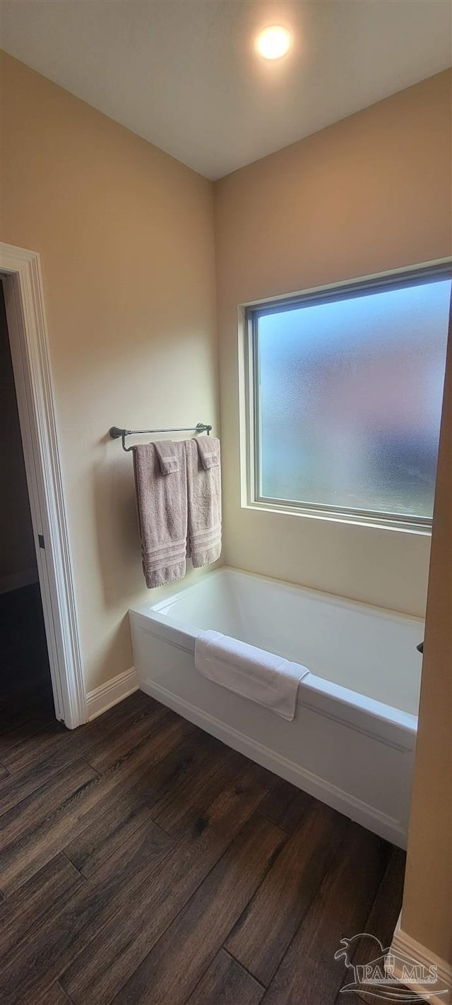 bathroom featuring hardwood / wood-style floors and a tub