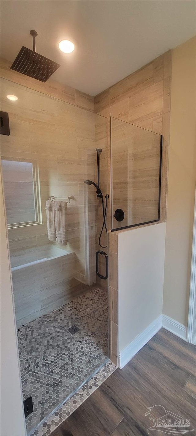 bathroom with wood-type flooring and walk in shower