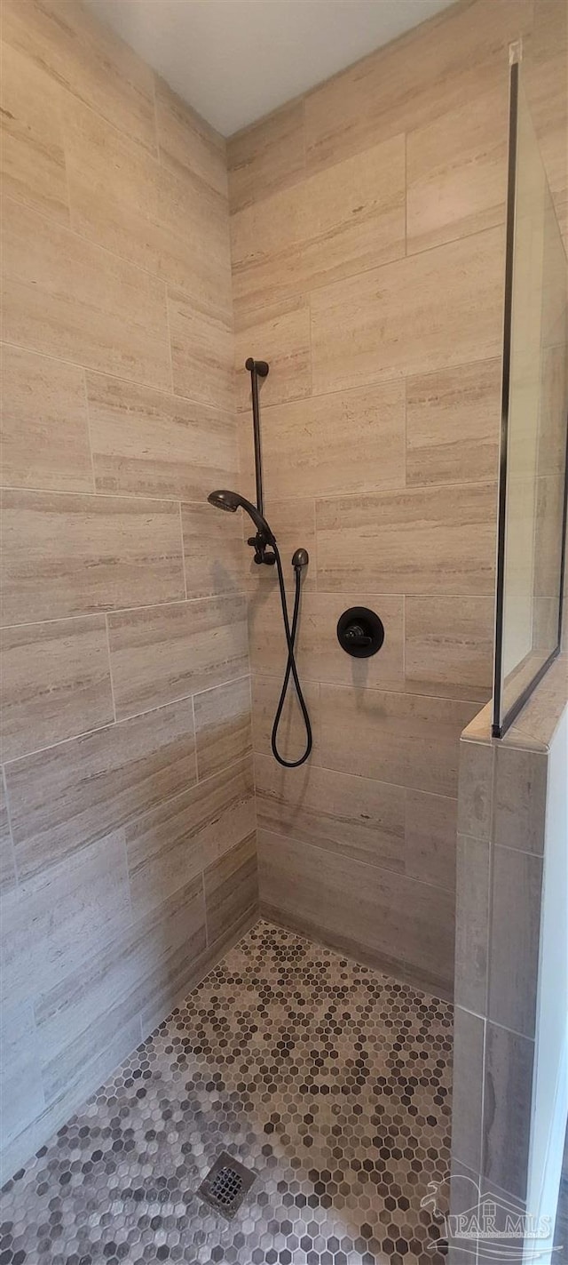 bathroom with tiled shower