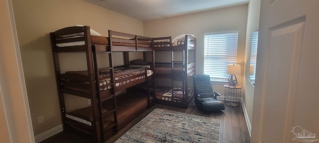 bedroom with dark hardwood / wood-style floors