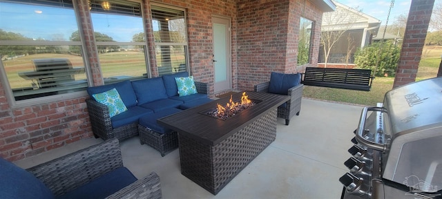 view of patio / terrace with an outdoor living space with a fire pit and grilling area