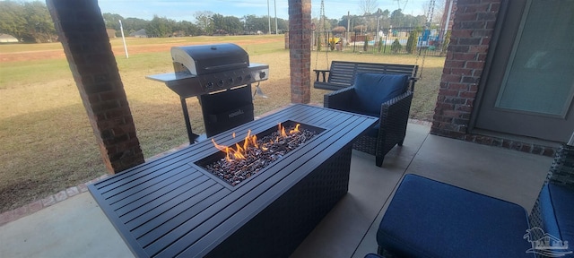 view of patio / terrace with an outdoor fire pit and grilling area