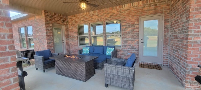 view of patio featuring ceiling fan and an outdoor living space with a fire pit