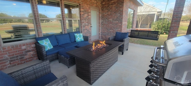 view of patio with an outdoor living space with a fire pit and grilling area