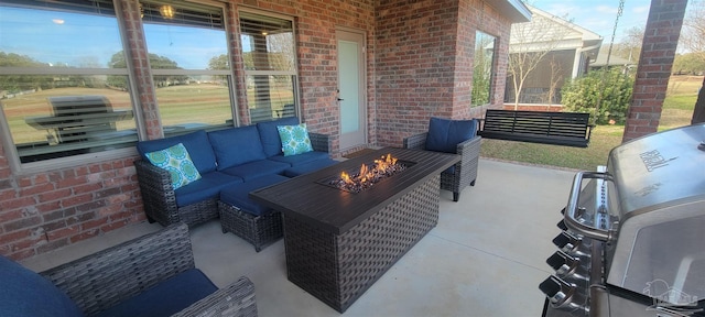 view of patio / terrace with an outdoor living space with a fire pit and grilling area