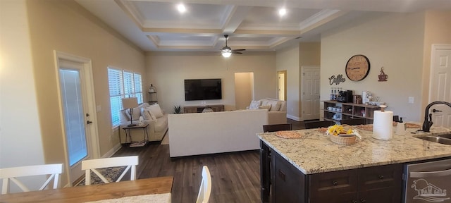 kitchen with sink, dishwasher, coffered ceiling, dark wood-type flooring, and a kitchen island with sink