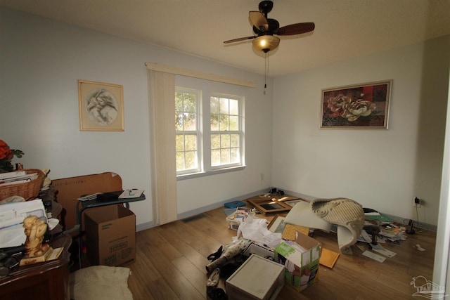 bedroom featuring visible vents, baseboards, and wood finished floors