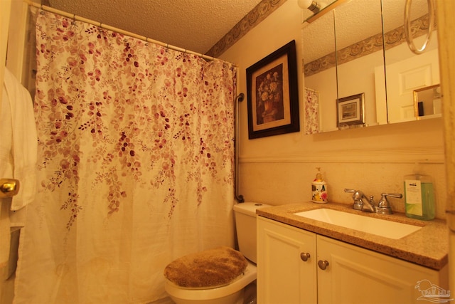 bathroom featuring vanity, curtained shower, toilet, and a textured ceiling