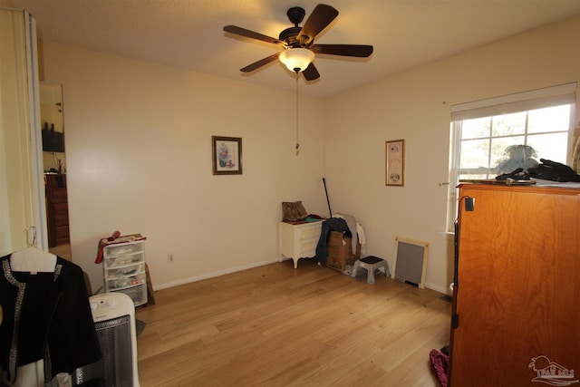 office with light wood-style flooring, baseboards, and ceiling fan