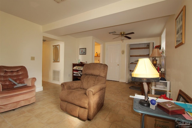 living room featuring visible vents, baseboards, and a ceiling fan