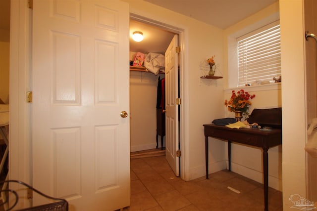 hall with tile patterned flooring and baseboards