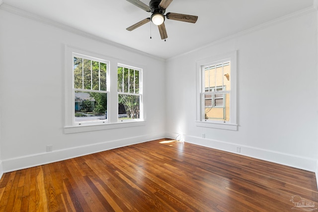 spare room with ceiling fan, baseboards, crown molding, and wood finished floors