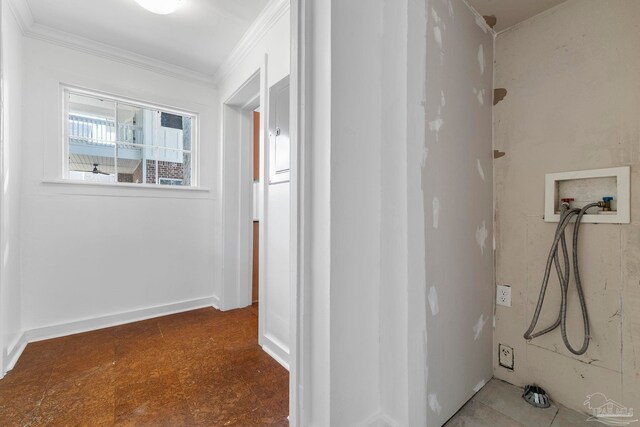 interior space with tile patterned floors, ornamental molding, and washer hookup