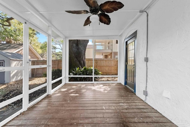 unfurnished sunroom with a ceiling fan