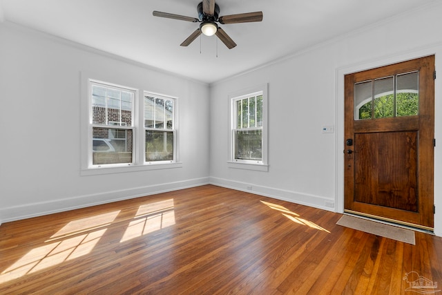 entrance foyer with baseboards, a ceiling fan, wood finished floors, and crown molding