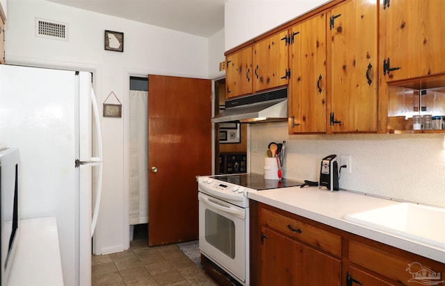 kitchen with sink, backsplash, and white appliances