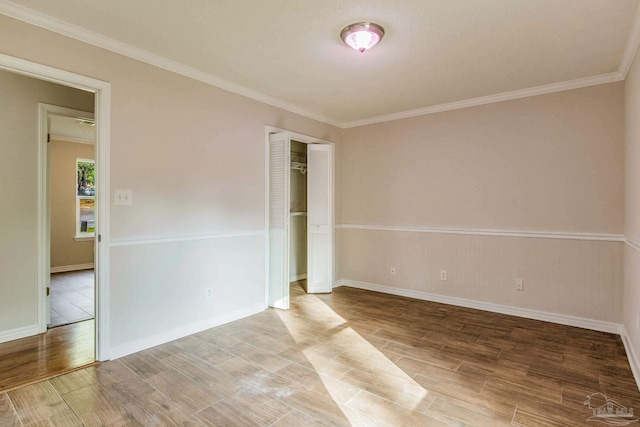 spare room featuring ornamental molding and hardwood / wood-style flooring