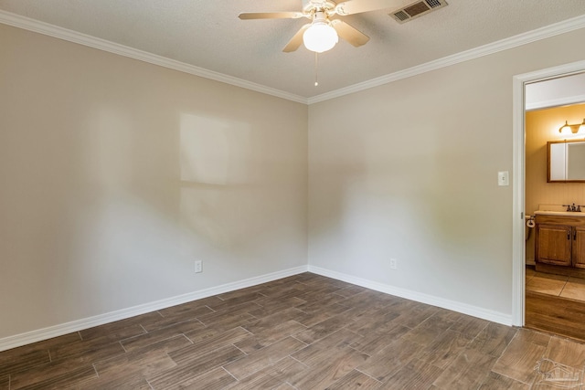 spare room with dark wood-type flooring, ceiling fan, crown molding, and a textured ceiling