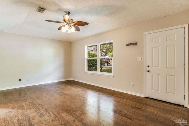 entryway featuring dark wood-type flooring, a textured ceiling, and ceiling fan