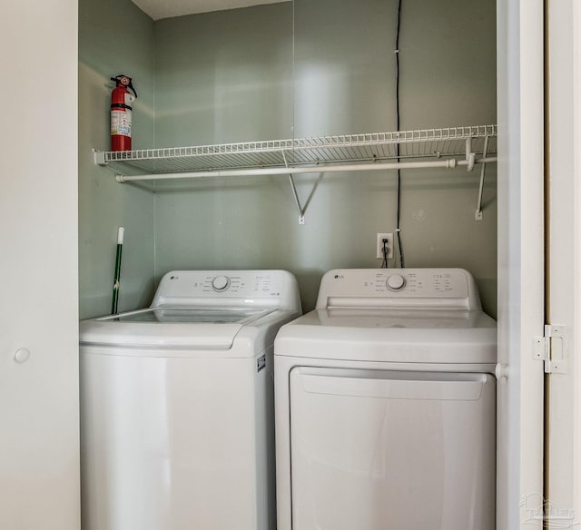 clothes washing area with independent washer and dryer