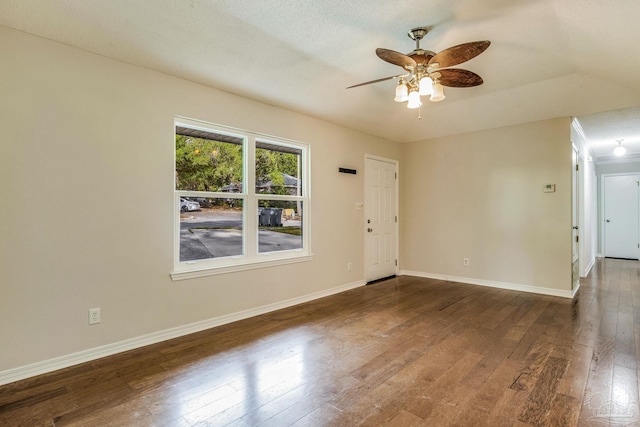 spare room featuring ceiling fan, lofted ceiling, a textured ceiling, and dark hardwood / wood-style flooring